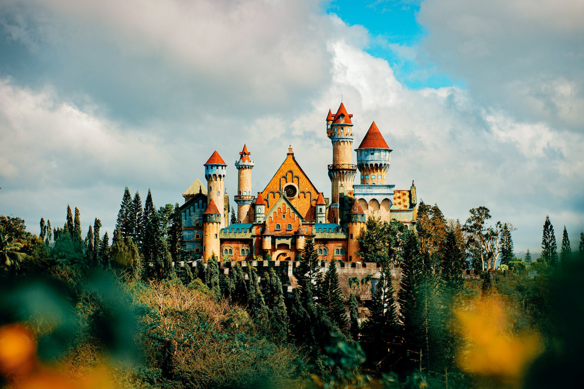 castle facade in theme park under cloudy sky